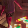 Child using the Lola Sense Lab LED Sensory Trail Set